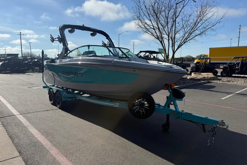 Slide: The Image of 2026 MasterCraft XT23 boat on trailer in parking lot, sunny day. - 5