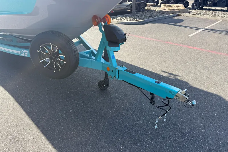 Slide: The Image of Trailer hitch of a 2026 MasterCraft XT23 boat in a parking lot. - 7