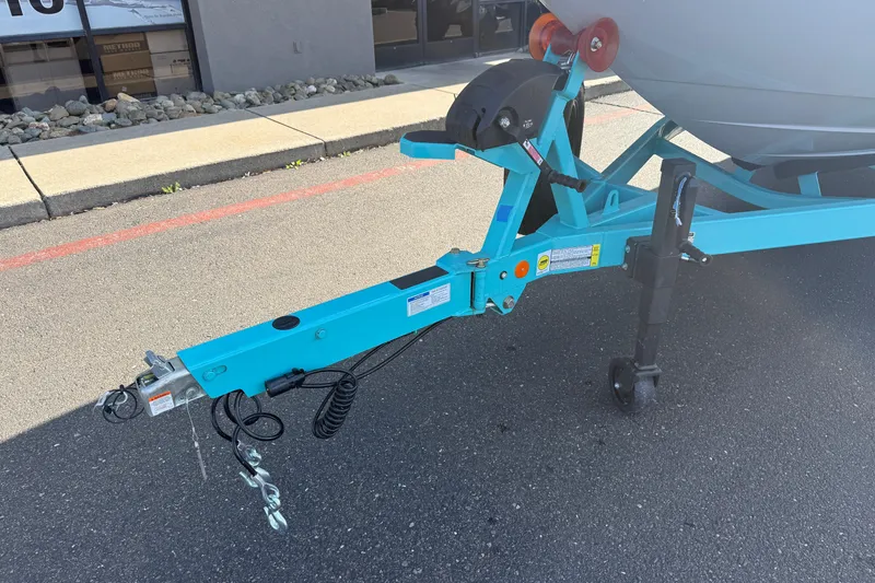 Slide: The Image of Trailer hitch of a 2026 MasterCraft XT23 boat on pavement. - 8