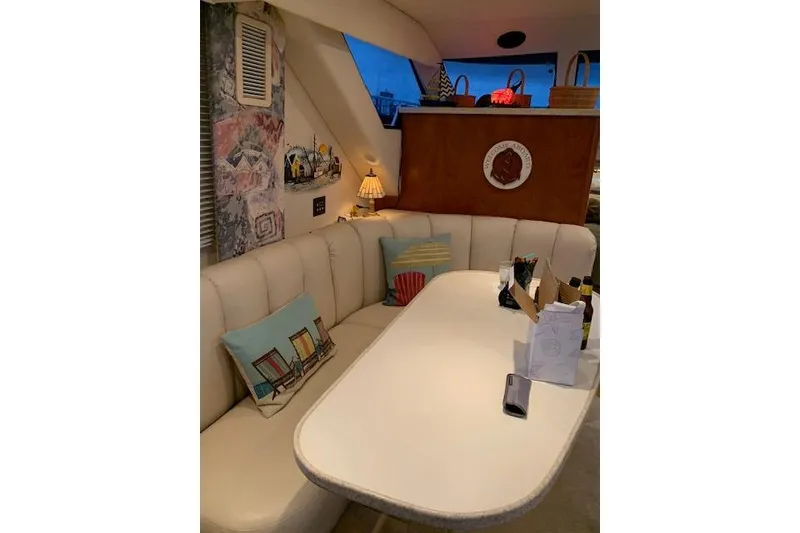 Slide: The Image of Interior of a 1999 Silverton 351 Sedan with cozy seating and decorative pillows. - 11