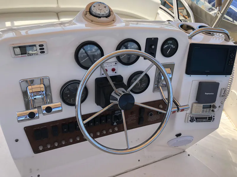 Slide: The Image of 1999 Silverton 351 Sedan helm with gauges and steering wheel. - 7