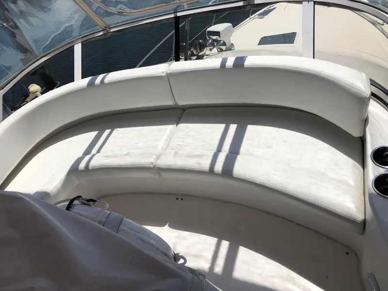 Slide: The Image of Interior of a 1999 Silverton 351 Sedan yacht with white seating. - 9