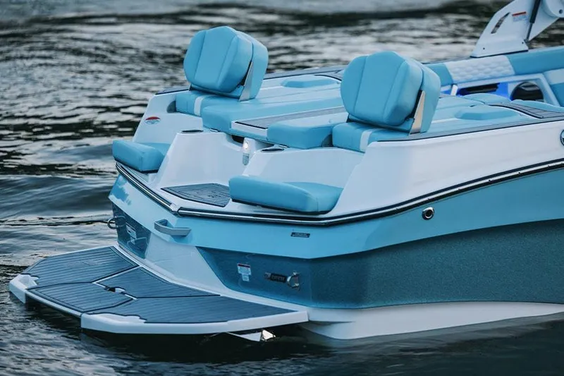 Slide: The Image of Manufacturer Provided Image: 2026 MasterCraft XT22 boat with blue seating on calm water. - 7