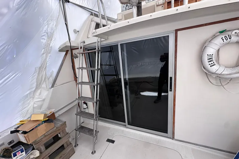 Slide: The Image of 1988 Silverton 37 Convertible boat deck with ladder and life preserver. - 10