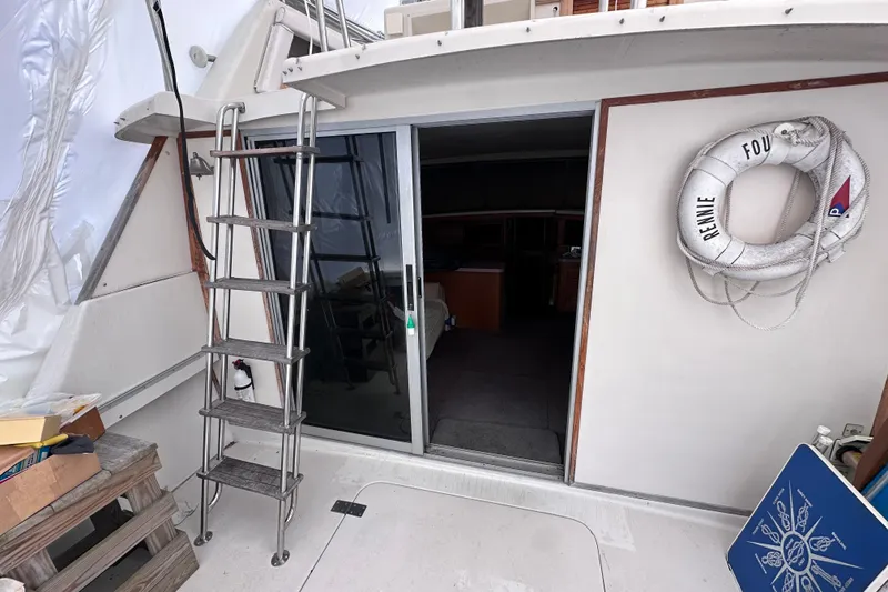 Slide: The Image of 1988 Silverton 37 Convertible boat deck with ladder and life preserver. - 13