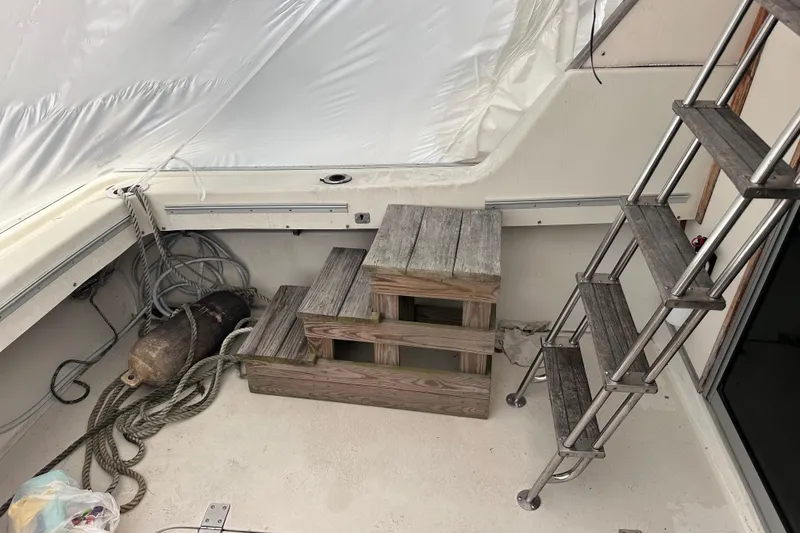 Slide: The Image of 1988 Silverton 37 Convertible boat interior with wooden steps and metal ladder. - 14