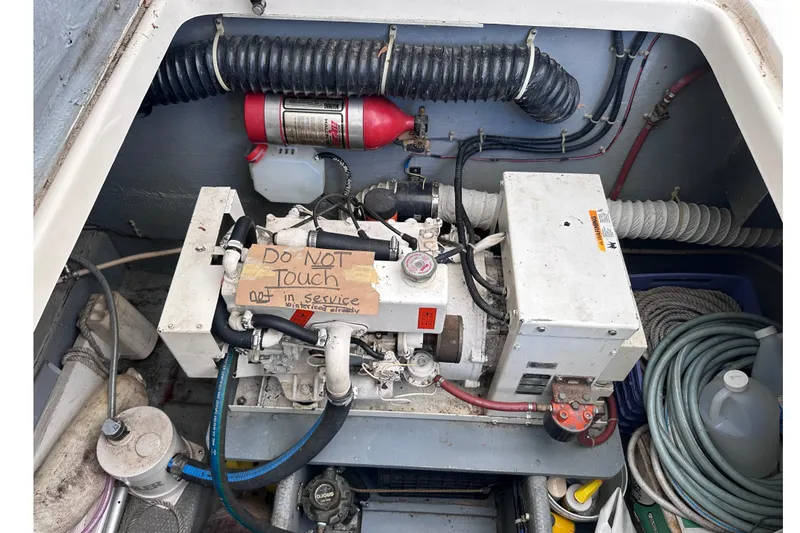 Slide: The Image of Engine compartment of a 1988 Silverton 37 Convertible with maintenance equipment. - 15