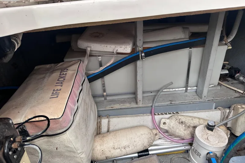 Slide: The Image of Storage area of 1988 Silverton 37 Convertible with life jackets and equipment. - 16