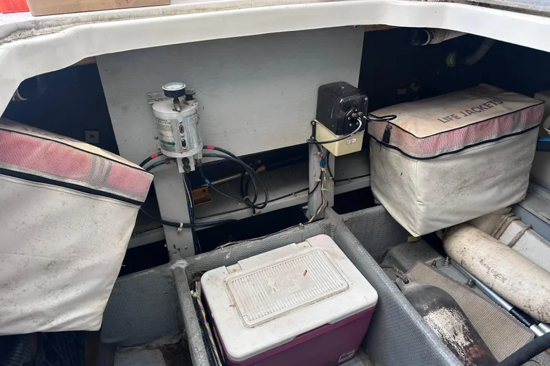 Slide: The Image of 1988 Silverton 37 Convertible boat storage area with life jackets and equipment. - 18