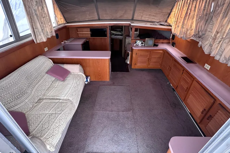 Slide: The Image of Interior of 1988 Silverton 37 Convertible yacht with cozy seating and wooden cabinetry. - 19