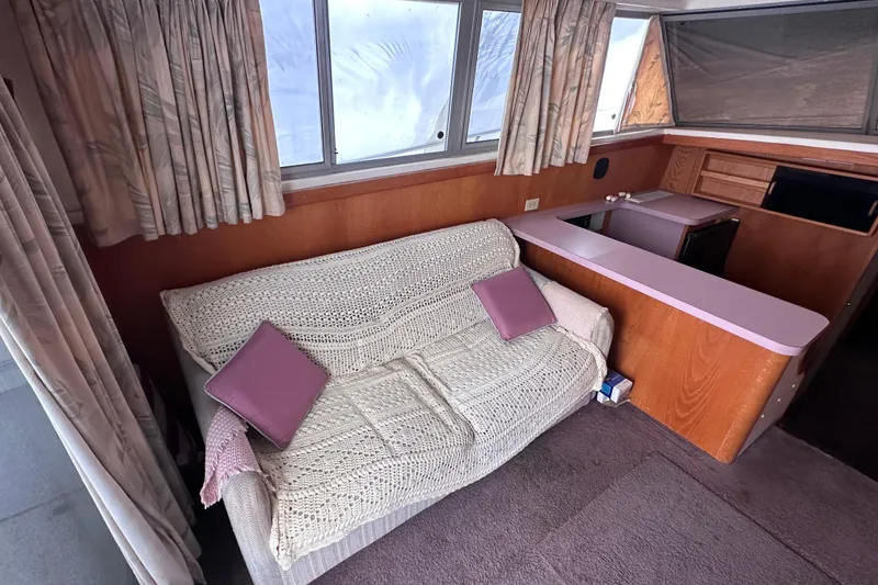 Slide: The Image of Interior of 1988 Silverton 37 Convertible with cozy sofa and kitchenette. - 20