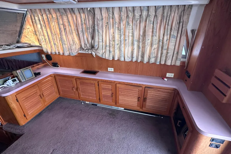 Slide: The Image of Interior of 1988 Silverton 37 Convertible yacht with wood cabinetry and vintage electronics. - 21