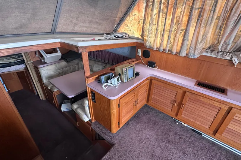 Slide: The Image of Interior of 1988 Silverton 37 Convertible yacht with wood cabinetry and seating area. - 22