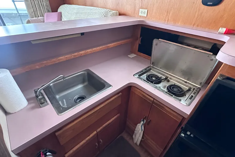 Slide: The Image of 1988 Silverton 37 Convertible kitchen with sink and two-burner stove. - 24