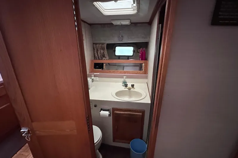 Slide: The Image of Bathroom interior of 1988 Silverton 37 Convertible yacht, featuring sink and mirror. - 26