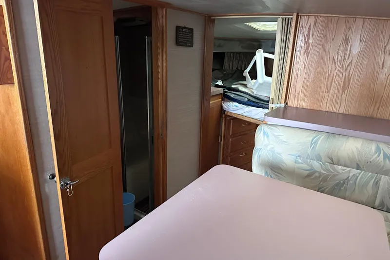 Slide: The Image of Interior of 1988 Silverton 37 Convertible boat with wood paneling and seating area. - 29