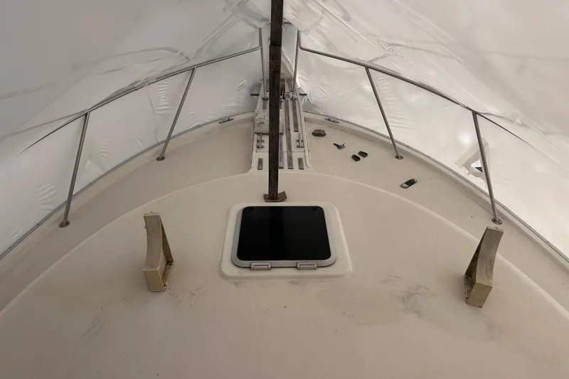 Slide: The Image of 1988 Silverton 37 Convertible boat deck under protective cover, featuring hatch and railings. - 3