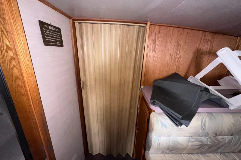 Slide: The Image of Interior of 1988 Silverton 37 Convertible with wooden paneling and folding door. - 30