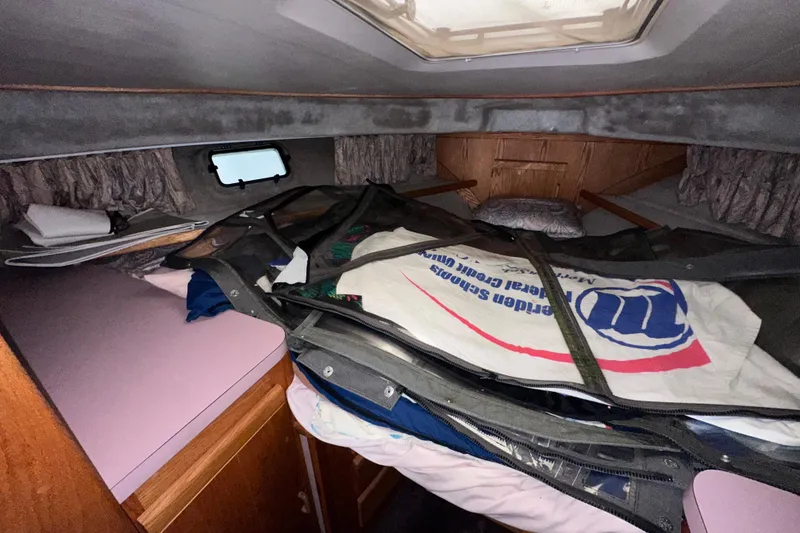 Slide: The Image of Interior cabin of 1988 Silverton 37 Convertible boat with storage and bedding. - 31