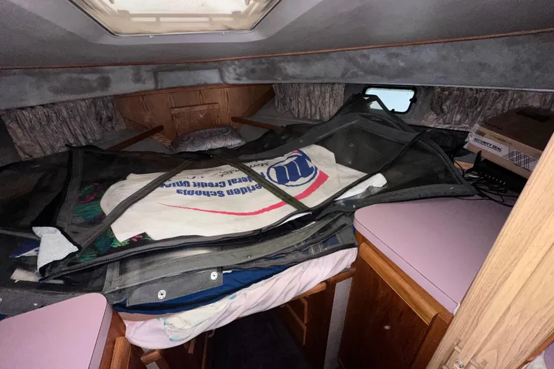 Slide: The Image of Interior cabin of 1988 Silverton 37 Convertible boat with storage items. - 32