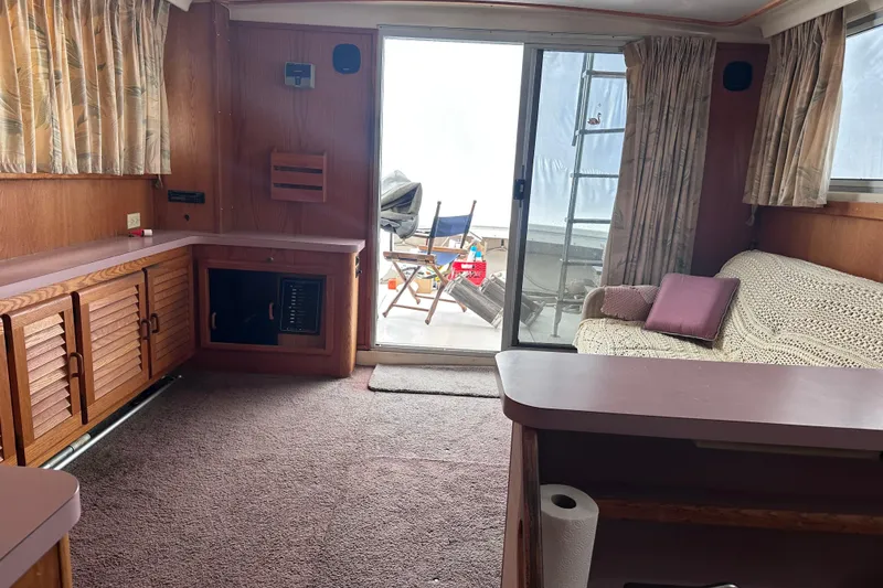 Slide: The Image of Interior of 1988 Silverton 37 Convertible yacht with cozy seating and wooden cabinetry. - 34