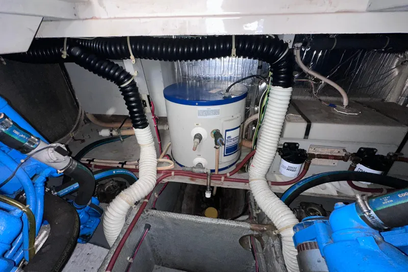 Slide: The Image of Engine room of a 1988 Silverton 37 Convertible boat with visible components and wiring. - 40