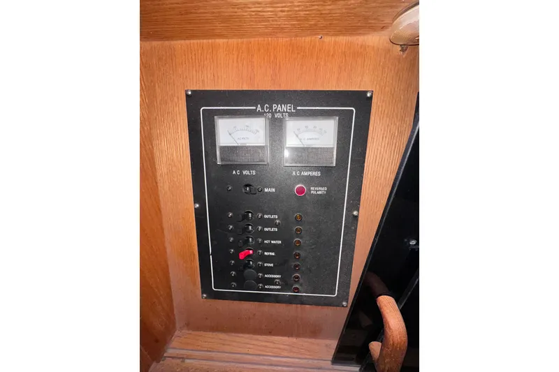 Slide: The Image of Electrical panel on 1988 Silverton 37 Convertible boat, featuring AC voltage and amperage meters. - 43