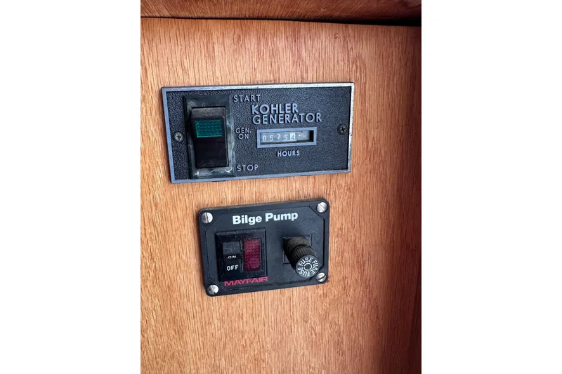 Slide: The Image of Control panel of a 1988 Silverton 37 Convertible with Kohler generator and bilge pump switches. - 46