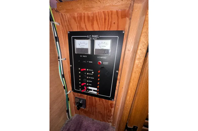 Slide: The Image of Electrical panel on a 1988 Silverton 37 Convertible boat, featuring AC voltage and amperage gauges. - 50