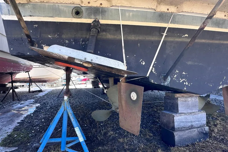 Slide: The Image of 1988 Silverton 37 Convertible boat hull and propeller on dry dock. - 6