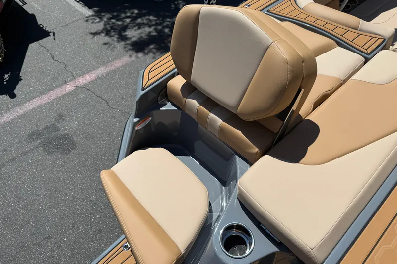 Slide: The Image of 2025 MasterCraft XT22 boat interior with tan and beige seating. - 12