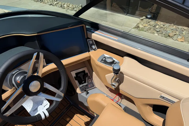 Slide: The Image of Interior of 2025 MasterCraft XT22 boat with modern steering and control panel. - 17