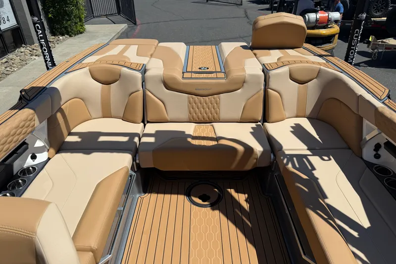 Slide: The Image of 2025 MasterCraft XT22 boat interior with luxurious tan seating and stylish design. - 21