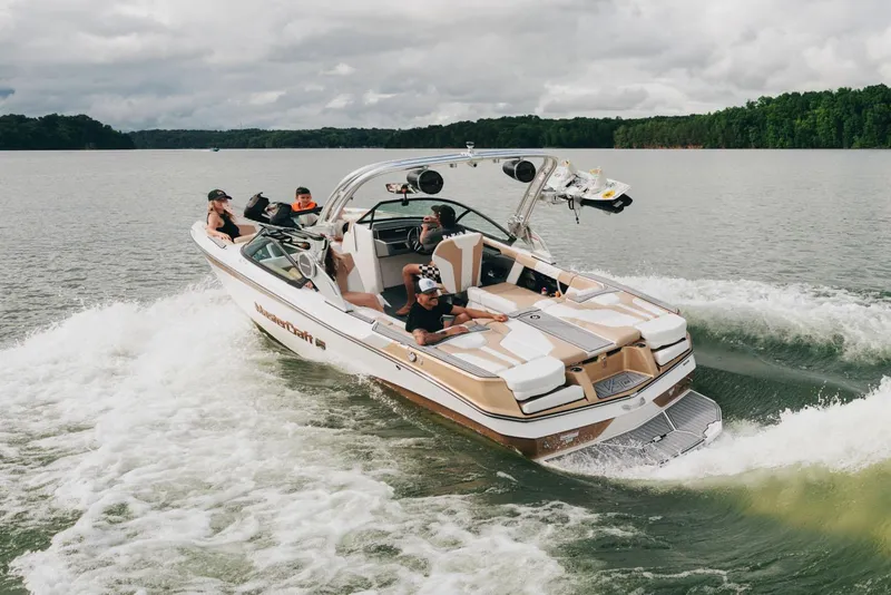 Slide: The Image of Manufacturer Provided Image: 2025 MasterCraft XT22 boat cruising on a lake with passengers enjoying the ride. - 32