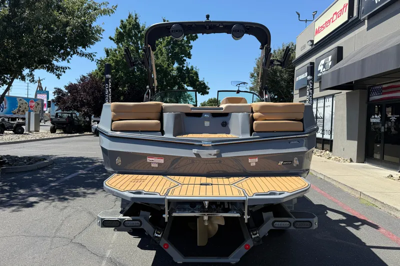 Slide: The Image of 2025 MasterCraft XT22 boat rear view with teak deck and seating. - 4
