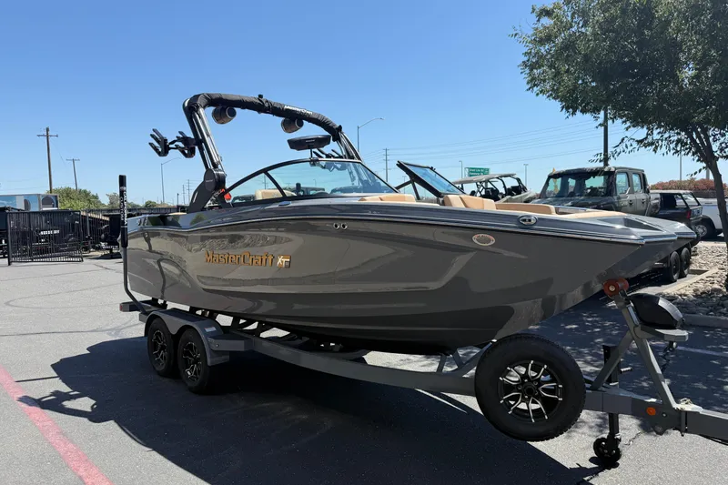 Slide: The Image of 2025 MasterCraft XT22 boat on trailer in outdoor setting. - 6