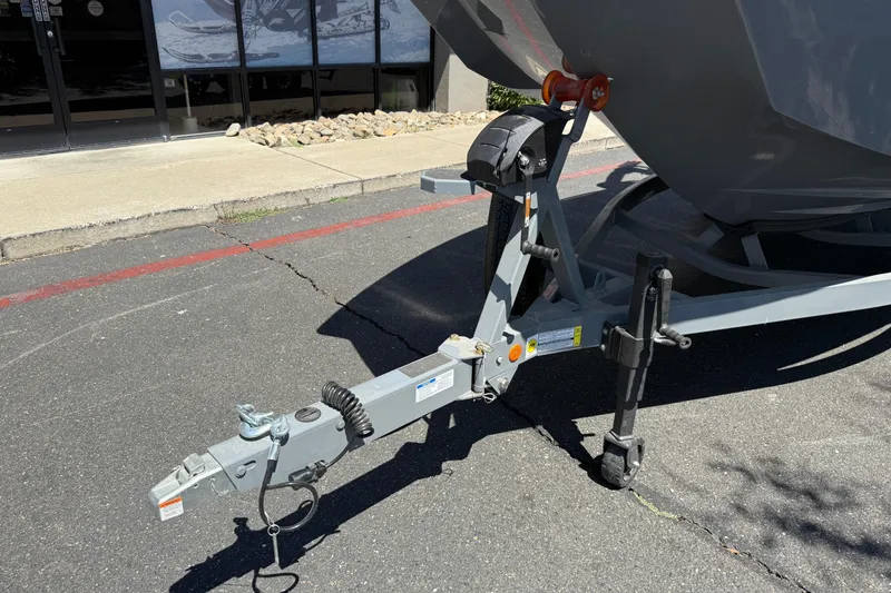 Slide: The Image of Trailer hitch of a 2025 MasterCraft XT22 boat on pavement. - 8
