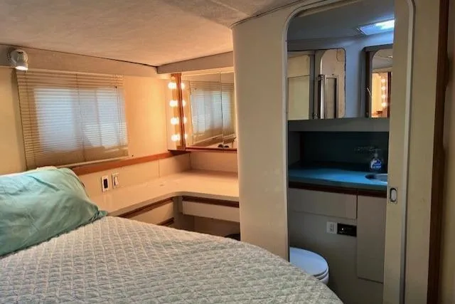 Slide: The Image of Interior of 1989 Trojan 12 Meter Motor Yacht with cozy bedroom and ensuite bathroom. - 14