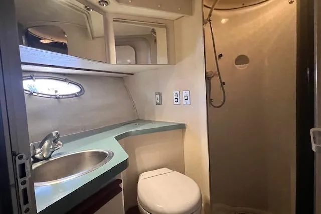 Slide: The Image of 1989 Trojan 12 Meter Motor Yacht bathroom with sink, toilet, and shower. - 16