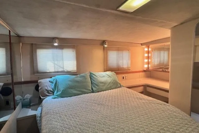 Slide: The Image of 1989 Trojan 12 Meter Motor Yacht bedroom with cozy bed and ambient lighting. - 18