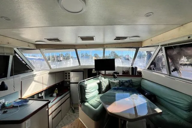 Slide: The Image of Interior of 1989 Trojan 12 Meter Motor Yacht with seating and panoramic windows. - 19