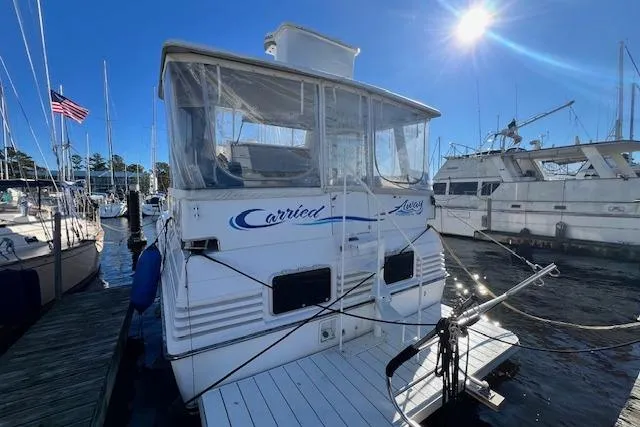 Slide: The Image of 1989 Trojan 12 Meter Motor Yacht docked at marina under clear blue sky. - 2