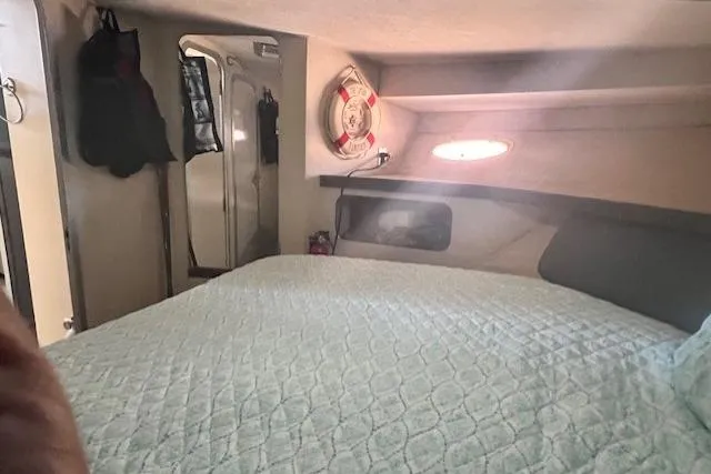 Slide: The Image of Interior cabin of a 1989 Trojan 12 Meter Motor Yacht with bed and porthole. - 20