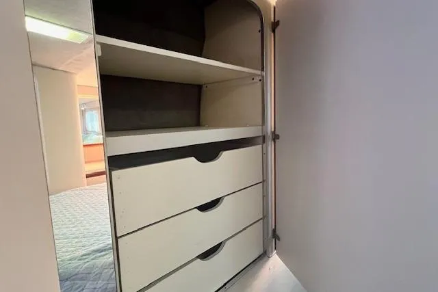 Slide: The Image of Interior storage of 1989 Trojan 12 Meter Motor Yacht with shelves and drawers. - 22