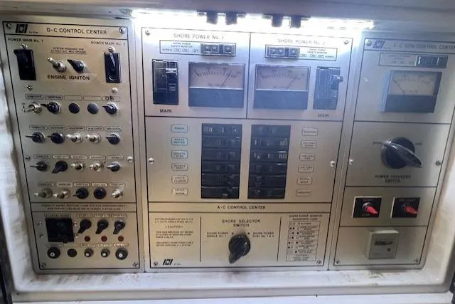 Slide: The Image of Control panel of a 1989 Trojan 12 Meter Motor Yacht with various switches and gauges. - 23