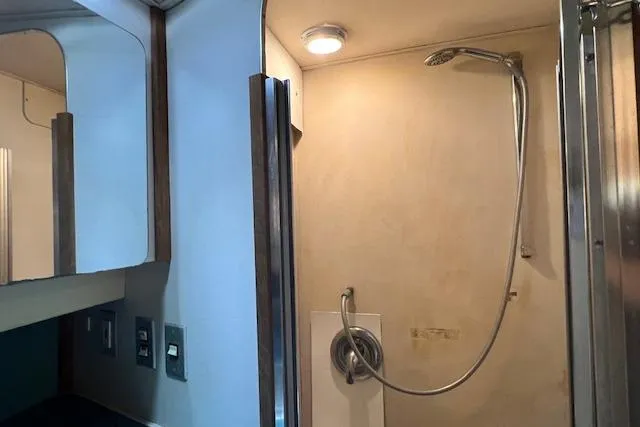 Slide: The Image of 1989 Trojan 12 Meter Motor Yacht bathroom with shower and mirrored cabinet. - 29