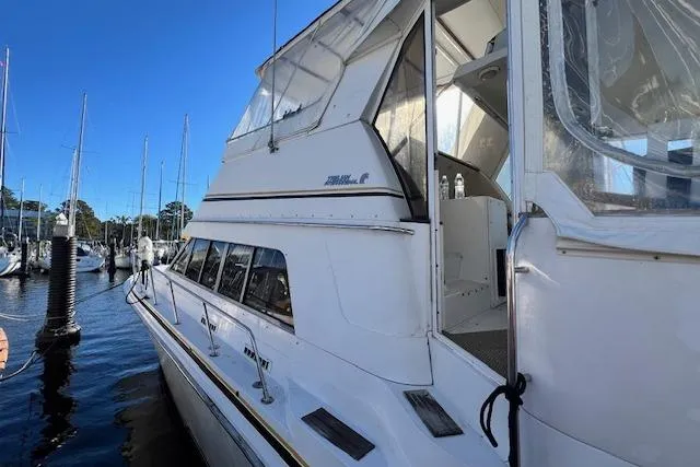 Slide: The Image of 1989 Trojan 12 Meter Motor Yacht docked at marina, side view. - 3