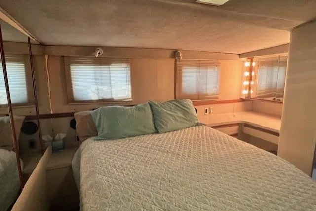 Slide: The Image of Bedroom interior of 1989 Trojan 12 Meter Motor Yacht with cozy bed and vanity area. - 30