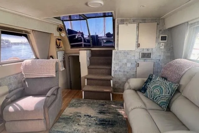 Slide: The Image of Interior of 1989 Trojan 12 Meter Motor Yacht with cozy seating and nautical decor. - 31