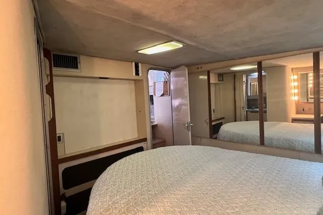 Slide: The Image of Interior of 1989 Trojan 12 Meter Motor Yacht bedroom with mirrored closet and bed. - 33